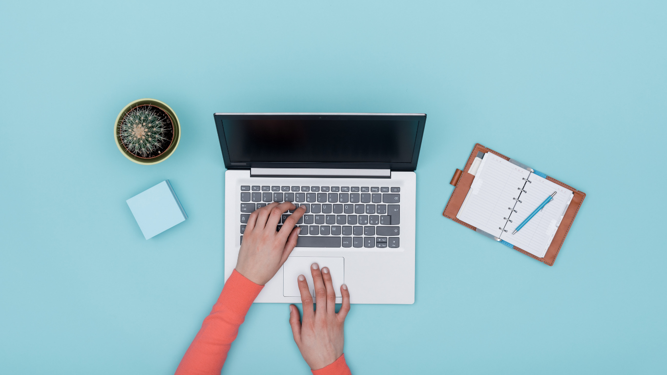 Image of a laptop and a note pad