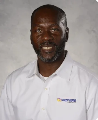 Man with a friendly smile wearing a white shirt with the Credit Repair logo.