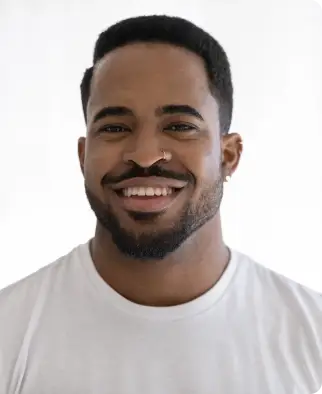 Smiling man with a beard wearing a white t-shirt.